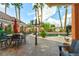 Outdoor patio with wrought iron chairs, an ornate lamp post, and landscaped surroundings offering a tranquil retreat at 3341 Camino Gardens Way, Las Vegas, NV 89146
