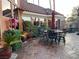 Stone patio with outdoor seating, lush greenery, and decorative planters offering an inviting space for relaxation and entertaining at 3341 Camino Gardens Way, Las Vegas, NV 89146