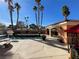 Backyard pool with a covered patio, seating, and lush greenery creating a serene outdoor living space at 3341 Camino Gardens Way, Las Vegas, NV 89146