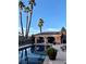 Scenic backyard pool and patio area with tropical palm trees and a covered seating area for relaxation at 3341 Camino Gardens Way, Las Vegas, NV 89146