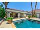 This home features a bar next to a swimming pool for outdoor entertaining at 3341 Camino Gardens Way, Las Vegas, NV 89146