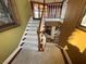 Carpeted staircase with custom wood railing leads to lower level at 3341 Camino Gardens Way, Las Vegas, NV 89146