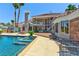 Backyard pool with a connecting spa area, basketball court, and patio seating at 3341 Camino Gardens Way, Las Vegas, NV 89146