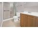 This bathroom features a vanity with wood-style cabinets and shower with glass doors at 3425 E Russell Rd # 114, Las Vegas, NV 89120