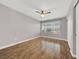 Spacious bedroom featuring wood floors, a ceiling fan, and a large window providing ample natural light at 3425 E Russell Rd # 114, Las Vegas, NV 89120