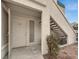 Front entrance to the condo unit with a white door and well-kept surroundings at 3425 E Russell Rd # 114, Las Vegas, NV 89120