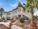 Inviting exterior view of the home featuring well-manicured landscaping and a lush palm tree at 3425 E Russell Rd # 114, Las Vegas, NV 89120