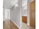 Hallway featuring a full bathroom with wood-style flooring, neutral paint, and a wooden cabinet at 3425 E Russell Rd # 114, Las Vegas, NV 89120