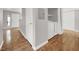 A convenient laundry area with a modern washer and dryer, adjacent to an entryway with wood floors at 3425 E Russell Rd # 114, Las Vegas, NV 89120