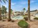 Resort-style pool surrounded by mature palm trees and lounge chairs at 3425 E Russell Rd # 114, Las Vegas, NV 89120