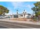 Charming single-story home featuring a modern gray garage door, white chimney, and well-kept front yard at 348 Upland Blvd, Las Vegas, NV 89107