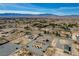 Aerial view of home with a circular driveway, desert landscaping, outbuildings and other homes in the distance at 4681 Melissa Ln, Pahrump, NV 89048