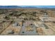 Aerial view of home with a circular driveway, desert landscaping, outbuildings and other homes in the distance at 4681 Melissa Ln, Pahrump, NV 89048