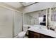 Bathroom with a shower and vanity with white countertops and a large mirror at 4768 W Montara Cir, Las Vegas, NV 89121