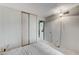 Neutral bedroom featuring sliding door closet, a unique hanging light, and connecting to a bathroom at 4768 W Montara Cir, Las Vegas, NV 89121