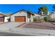 A cozy single-story home featuring a red garage door and a well-kept front yard at 4768 W Montara Cir, Las Vegas, NV 89121