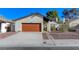 Charming single-story home featuring a red garage door and low-maintenance landscaping at 4768 W Montara Cir, Las Vegas, NV 89121