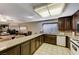 Open kitchen with breakfast bar, tile flooring, and built-in appliances at 4768 W Montara Cir, Las Vegas, NV 89121