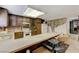 The kitchen shows light countertops, dark cabinets and a tile floor at 4768 W Montara Cir, Las Vegas, NV 89121