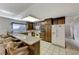 Traditional kitchen featuring dark wood cabinetry and granite countertops, adjacent breakfast bar seating at 4768 W Montara Cir, Las Vegas, NV 89121