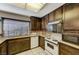 Galley kitchen featuring modern appliances, granite counters, and ample cabinet space at 4768 W Montara Cir, Las Vegas, NV 89121