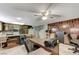 Cozy living space featuring a retro bar, wood paneled accent wall, ceiling fan, and comfortable workspace at 4768 W Montara Cir, Las Vegas, NV 89121