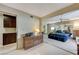 Bright main bedroom featuring a brick accent wall, ceiling fan, and a view of the exterior at 4768 W Montara Cir, Las Vegas, NV 89121