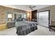Comfortable primary bedroom with unique brick wall, accent mirrors, and sliding glass doors at 4768 W Montara Cir, Las Vegas, NV 89121