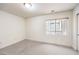 Cozy bedroom with neutral carpet, window with blinds, and closet providing a blank canvas at 4787 Essen Ct, Las Vegas, NV 89147