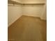 Spacious carpeted walk-in closet features neutral paint, baseboards, and wooden shelving at 4787 Essen Ct, Las Vegas, NV 89147