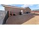 View of the rear exterior with neutral stucco and covered patio at 50 White Burch Ln, Pahrump, NV 89048