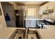 Bright kitchen with stainless steel appliances, a modern countertop, a gas range, and white cabinetry at 5000 Red Rock St # 228, Las Vegas, NV 89118