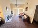 Bright living room with vaulted ceilings, a ceiling fan, a sliding glass door and a fireplace at 5000 Red Rock St # 228, Las Vegas, NV 89118