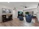 Bright living room with hardwood floors, modern furnishings, and a large flat screen television at 5168 Wilbur St, Las Vegas, NV 89119