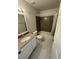 Clean bathroom with granite counters, vanity, tub-shower combo, and tiled flooring at 5241 River Glen Dr # 184, Las Vegas, NV 89103