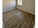 Bedroom with laminate flooring, base trim and natural light at 5241 River Glen Dr # 184, Las Vegas, NV 89103