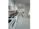Functional kitchen features white appliances, granite countertops, and tiled flooring at 5241 River Glen Dr # 184, Las Vegas, NV 89103