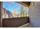 Private balcony with a view of the surrounding trees and building at 5250 S Rainbow Blvd # 2120, Las Vegas, NV 89118