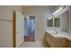 Bathroom with a single sink vanity, tile flooring, and access to hallway and shower-tub combo at 5250 S Rainbow Blvd # 2120, Las Vegas, NV 89118