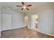 Bright bedroom with wood floors, ceiling fan, and multiple doors leading to other areas of the home at 5250 S Rainbow Blvd # 2120, Las Vegas, NV 89118