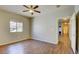 Well-lit bedroom with wood floors, a window, and a view into a hallway with a fireplace at 5250 S Rainbow Blvd # 2120, Las Vegas, NV 89118