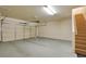 Spacious garage with a garage door, staircase, and ample room for parking and storage at 5250 S Rainbow Blvd # 2120, Las Vegas, NV 89118
