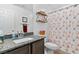 Bathroom featuring a granite countertop, a decorative starfish shower curtain and accent shelving at 550 Dawson Falls Ave, Indian Springs, NV 89018