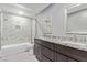 Beautiful bathroom showcasing a double vanity, granite countertops, tile flooring, and a shower-tub combo at 5525 Campbell Rd, Las Vegas, NV 89149