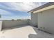 The patio with a rooftop, and gray paint, offers an open-air space to enjoy the views at 5525 Campbell Rd, Las Vegas, NV 89149