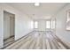 Spacious living area featuring wood floors, white walls, and bright windows, perfect for entertaining or relaxation at 603 W Adams Ave, Las Vegas, NV 89106