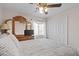 Comfortable bedroom with a ceiling fan, dresser with mirror, and a closet at 7017 Pink Flamingos Pl, North Las Vegas, NV 89084