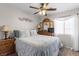 Bedroom showcasing comfortable bedding, a ceiling fan, and dresser, creating a cozy and inviting space at 7017 Pink Flamingos Pl, North Las Vegas, NV 89084