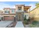Beautiful two-story home with stone accents, a balcony, and well-manicured landscaping at 7017 Pink Flamingos Pl, North Las Vegas, NV 89084