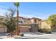 Two story home with a three car garage, desert landscaping and stacked stone front accents at 7017 Pink Flamingos Pl, North Las Vegas, NV 89084